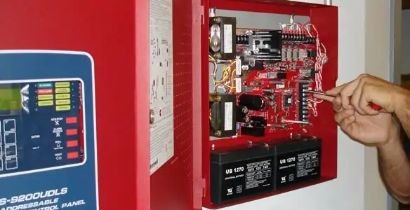 fire alarm installation service showing technician configuring fire alarm control panel in Harrisburg, PA