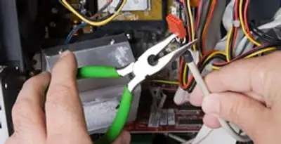 Licensed electrical contractor performing electrical repair with tools in Mechanicsburg, PA