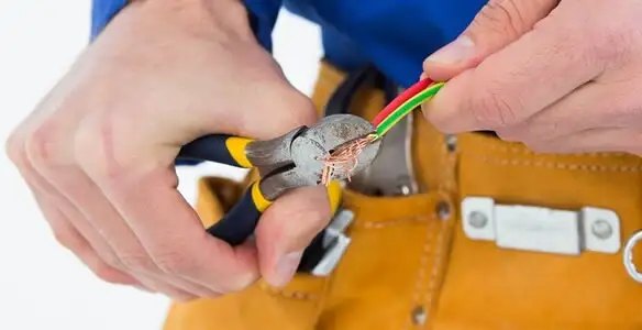licensed electrician securing electrical wiring with professional tools during service work in Harrisburg, PA