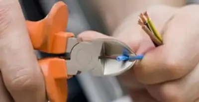 licensed electrician performing precise wire cutting and preparation during electrical service in Harrisburg, PA