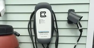 Outdoor electric vehicle charger installation on residential wall in Harrisburg, PA
