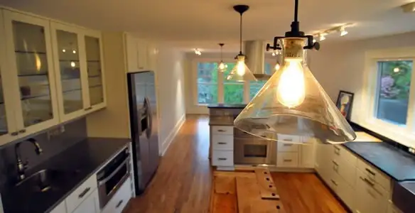 Residential electrician installing modern indoor light fixture in a home in Harrisburg, PA